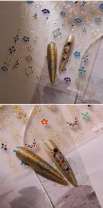 Macro detail of M-611 3D embossed nail stickers with blue floral and butterfly patterns