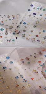 Macro detail of M-610 embossed nail stickers with gold floral and butterfly patterns