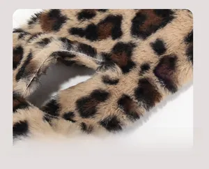 Macro shot of faux fur leopard scarf showing dense texture and functional slit closure