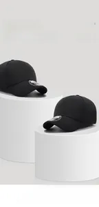 Close-up of black breathable mesh baseball cap with silver sticker on minimalist stand
