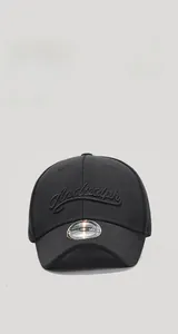 Detailed view of Andrewlph 3D embroidery on a black short brim baseball cap