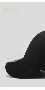 Detail view of black short-brim baseball cap showing 5.5cm brim and breathable eyelets
