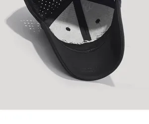 Detail showing the inner silver lining and breathable laser-cut holes of the black baseball cap