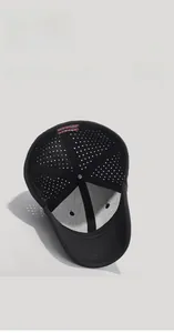 Detail view of black baseball cap showing breathable mesh inner structure and red brand label