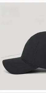 Close-up of black short brim baseball cap showing 5cm brim length and twill texture