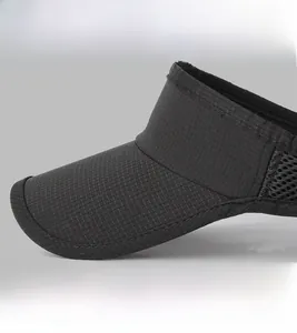 Detail of black sports visor showing mesh texture and high-quality stitch work on the brim