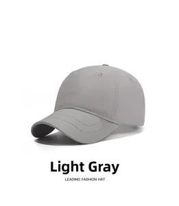 Detail view of light gray waterproof baseball cap with breathable eyelets and curved brim