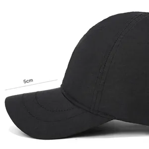 Waterproof black baseball cap with a 5cm short brim and reinforced stitching detail