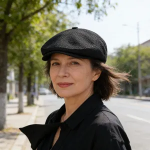 Classic black newsboy cap with textured fabric finish shown in an outdoor setting