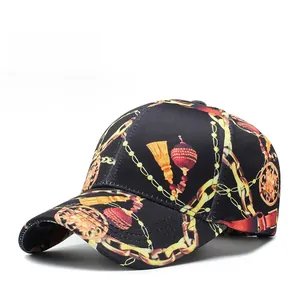 Detail of black baseball cap featuring golden chain patterns and red tassel print