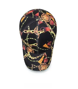 Top view of a black cotton baseball cap featuring vintage gold chain and tassel prints