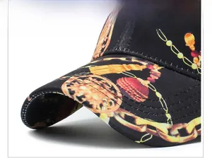 Detailed macro view of black baseball cap brim with golden chain prints and durable stitching