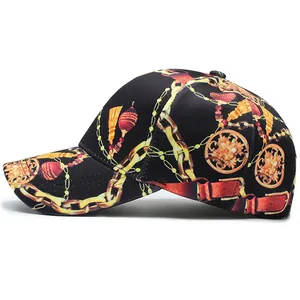Side view of a black baseball cap with golden baroque prints and a curved brim