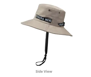 Side view of beige bucket hat featuring metal vents and adjustable black windproof cord