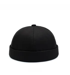 Front view of black brimless docker cap showing six-panel stitching and canvas texture