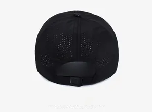 Detail of black sports cap featuring laser-cut ventilation holes and adjustable back strap