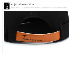 Detail view of adjustable leather strap and stitching on black cotton brimless cap