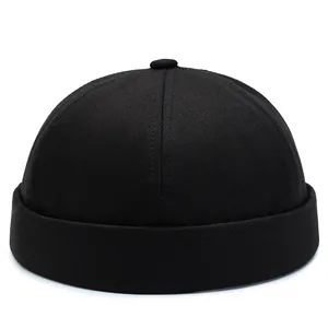 Classic black cotton docker hat with a minimalist brimless design and top button detail