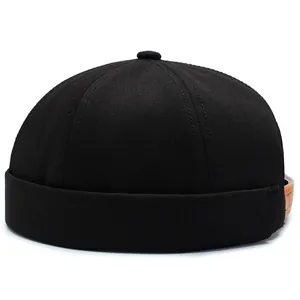 Classic black brimless docker cap in premium cotton canvas with adjustable leather strap