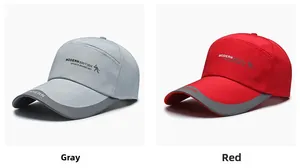 Detail of grey and red baseball caps featuring Modern British embroidery and long brims