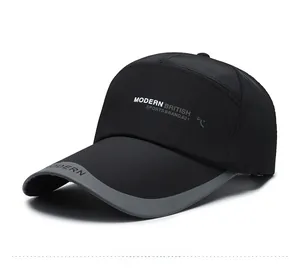 Close-up of black baseball cap side with white Modern British sports text and logo