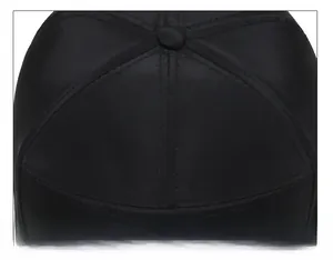 Close-up of durable six-panel crown stitching and top button on a black baseball cap