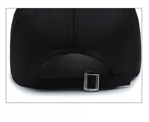 Detail of adjustable metal buckle and black fabric strap on the back of baseball cap