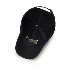 Internal view of black baseball cap showing reinforced seams and adjustable metal buckle