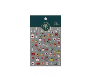 Detailed 3D embossed Christmas nail stickers featuring reindeer and gingerbread man motifs