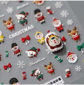 Macro detail of 3D embossed Christmas nail stickers featuring Santa and reindeer designs