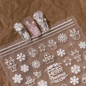 3D embossed white Christmas nail stickers with snowflakes, Santa, and pearl accents