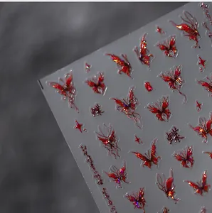 Macro detail of red butterfly and star embossed nail stickers with laser effect