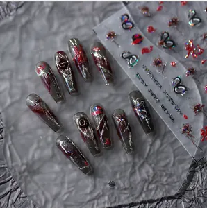 Macro detail of dark gothic dragon press-on nails with 3D silver relief and red accents