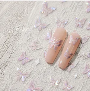 Macro detail of iridescent butterfly nail stickers with pearlescent finish on long nails