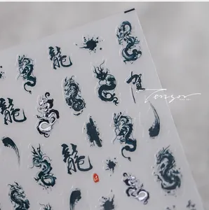 Detailed macro of ink-wash dragon nail stickers with traditional calligraphy accents