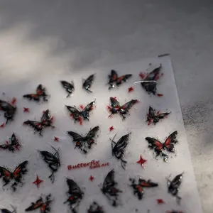 Close-up of 5D butterfly nail stickers with black and red butterfly and star patterns