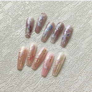 Macro detail of 3D dragon pattern nail stickers with gold foil and calligraphy art