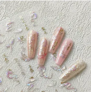 Detailed 5D relief nail art sticker featuring golden dragon and phoenix on pink gradient nails