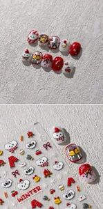 Detailed view of winter themed nail stickers with cute white bears and golden bells