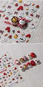 Detailed view of winter puppy 3D nail stickers with scarves, bells and cozy treats