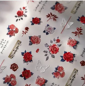 Macro shot of embossed vintage rose and butterfly nail stickers with floral patterns