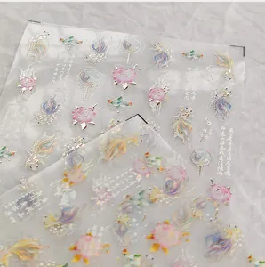 Detail of Chinese koi fish nail stickers with gold foil accents and lotus patterns