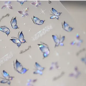 Macro detail of holographic purple butterfly nail stickers with laser iridescent finish