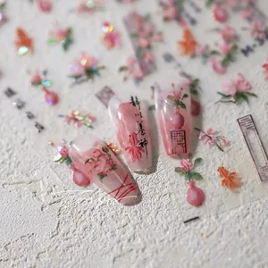 Macro detail of Chinese style nail stickers featuring peach blossoms and goldfish designs