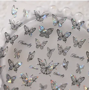 Vista macro di adesivi olografici per unghie a farfalla con finitura laser argento su pelo