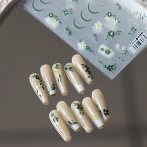 Floral embossed nail stickers TS-3655 with green leaves and white flowers on beige nails