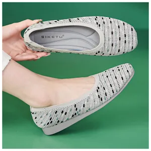 Detailed view of grey knit flat shoes featuring arch support and breathable wave pattern