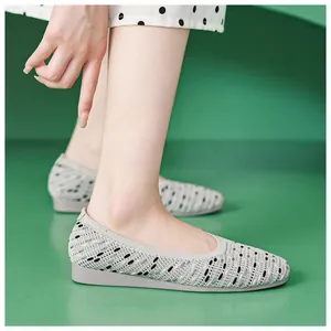 Detail of grey knitted flat shoes featuring breathable mesh texture and comfortable round toe