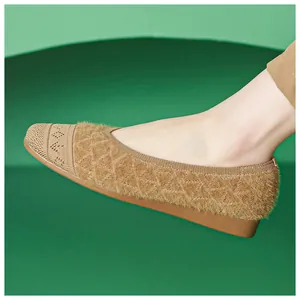 Detail of tan knitted flat shoe with plush textured patterns and hollow toe design
