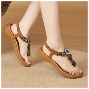 Detail view of Bohemian sandals with colorful beads and gemstones on brown leather straps
